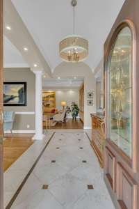 An 11' barrel-vaulted ceiling welcomes guests into a refined entry, setting a tone for the home’s elegance and gracious flow.