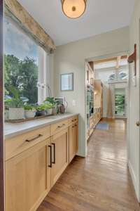 A sunlit butler's pantry flows seamlessly into the heart of the home.
