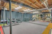 This space is currently being used as a spacious home gym. The 1/2" thick rubber flooring (measures 16' x 12'), and wall mounted mirror were installed January 2025.