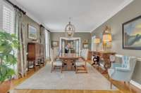 The formal dining room provides dining space for elevated gatherings. This home has real wood plantation shutters and sand and finish white oak floors throughout.