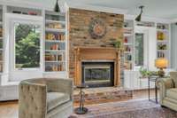 This space is cozy and inviting with natural light streaming through large windows and direct access to the covered deck.