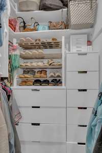 The closet has wonderful drawers and shelves.