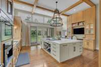 Executed by Craig Huseby, the kitchen renovation included raising the ceiling to add walls of windows and wood beams.