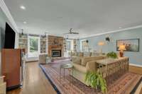This sunny space enjoys beautiful views of the backyard offers a fireplace and custom book shelves.