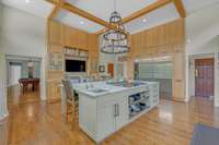 White oak custom cabinetry by Gaertner Cabinet Company anchor a 10' solid slab quartzite island. Every detail was considered, down to ensuring there are no seams in the countertops.