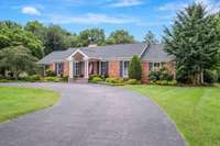 A circular driveway provides ample parking for guests. This home offers peace of mind with all  upgraded major systems including a new roof, new HVACs, and more.