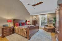 The owner's suite offers a vaulted ceiling, plantation shutters, and sitting area. The stylish propeller ceiling fan was just replaced.