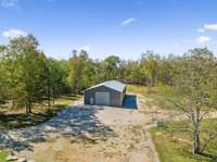 3200 sq ft (80x40) separate shop / barn with electric garage door, concrete floor, & electricity