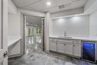 Kitchenette on lower level with counter area, sink and fridge
