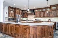 Island Kitchen, custom cabinets, Z-Line stove, double oven with Pot filler and hidden spice racks.