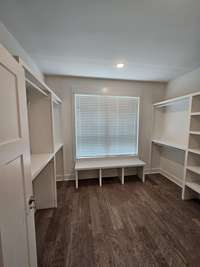 primary closet with custom built ins