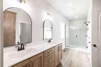 Primary bath has double vanity, all custom cabinetry with designer finishes!