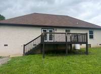 Back view of home with large deck
