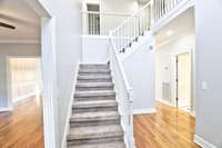 Welcome in. A formal living room to the left and your first bed and bath to the right.