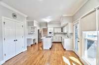 This spacious eat-in kitchen includes a generous sized pantry and a spot for a work space.