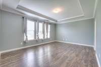 First-floor primary bedroom suite with trey ceiling.