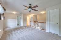 Atop the stairs, you'll find a large family room with extra storage.