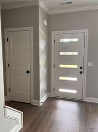 Coat Closet and Front door. There is new paint in the Kitchen & Great Room