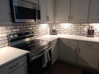 Custom Brick Backsplash and under the counter lighting.