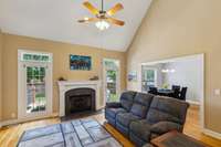 Great room with fireplace and access to deck and fenced backyard
