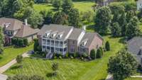 What a wonderful location & lot! This does not back to Wilson Pk but instead has privacy trees behind the house so you don't notice the house behind this one