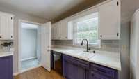 Updated kitchen cabinets and sink, custom pull outs (spice rack and trash), and under cabinet lighting