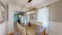 New chandelier and wainscoating with a view of the expansive back yard to enjoy all of your family meals