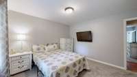 Spacious guest bedroom with oversized, custom closet and a beautiful view of the backyard