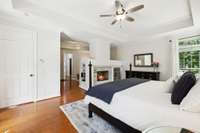 Welcome to your primary wing....spacious bedroom (that has a private door onto your back patio), double sided gas fireplace, and beautiful windows.