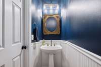 The powder room tucked away in the foyer...perfect for everyone to wash up and enjoy breaking bread together.