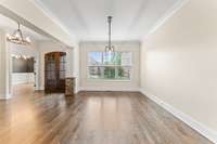 The spacious foyer area gives room to welcome your guests and opens to the beautiful finishes and lighting of the office and dining room.