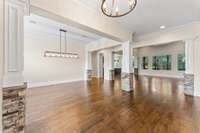 The entry foyer leads to a formal dining room on the left and an office with double French doors on the right.