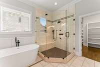 The shower area is beautifully tiled, and the window in the bath provides lovely natural light.