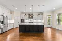 The kitchen underwent an extensive remodel in 2023, featuring cabinets upgraded with 
soft-close doors and drawers, a spacious island with abundant storage, new hardware, modern appliances, updated countertops, a pot-filler,& a tiled backsplash.