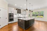 The walk-in pantry has custom shelving, and all cabinets have been maximized for optimal storage.