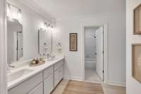 The updated full bathroom, with a quartz double vanity, is attached to bedroom 2.
