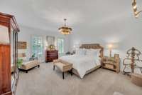 The retreat-like, main floor primary suite includes two walk-in closets and elevated bathroom.