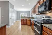 Spacious Kitchen With All Granite Countertops