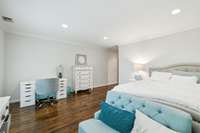 2nd floor bedroom with hardwood floors, crown molding, & a walk-in closet