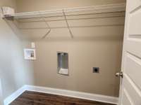 Separate Laundry Room with Waterproof Plank Flooring.