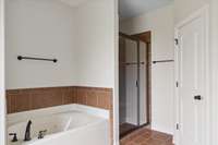 Primary Bathroom with jetted tub and walk-in shower.