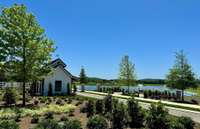 Adorable "Gate House" with lush landscaping and view of pond with fountains welcomes you home. Come feed the geese!