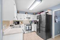 Brand new stove! The white cabinets really enhance the kitchen area