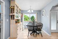 Tiled eat in kitchen with lots of natural lighting
