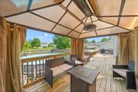 Beautiful, canopied area on the extended back deck. Perfect for quietly sitting or entertaining.