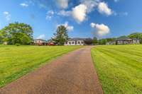 Massive yard with aggregate driveway allows for plenty of parking for cars, campers, boats, etc.