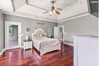 Primary bedroom has door leading to back porch, trey ceiling and allows plenty of room for even the largest of furniture