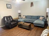 Beautiful flooring in living room with ceiling fan
