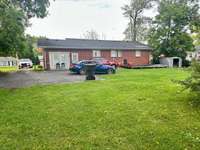 Back of house with plenty of parking and large yard