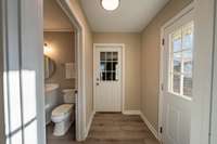 Access to back deck, half bath, laundry room and garage